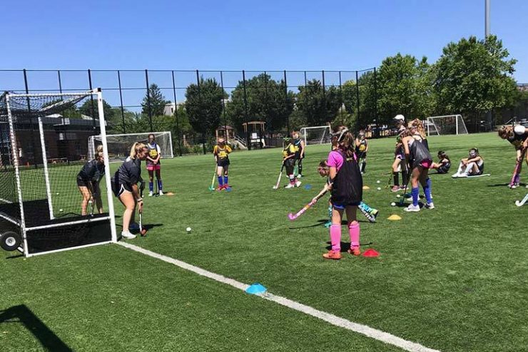 While at Adelphi University, campers are placed into small groups to work on their field hockey fundamentals.